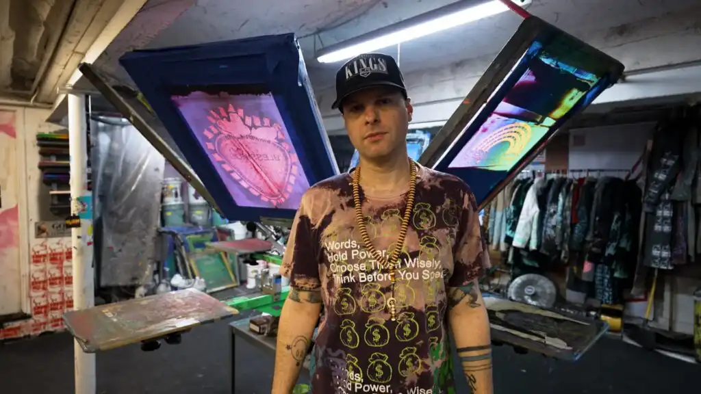 Doobie Duke Sims screen printing T-shirts for Snow Milk, his streetwear brand launched from a Brooklyn basement.