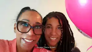 Flecia Brown and her daughter advocating for cancer research funding, highlighting family support and community involvement.