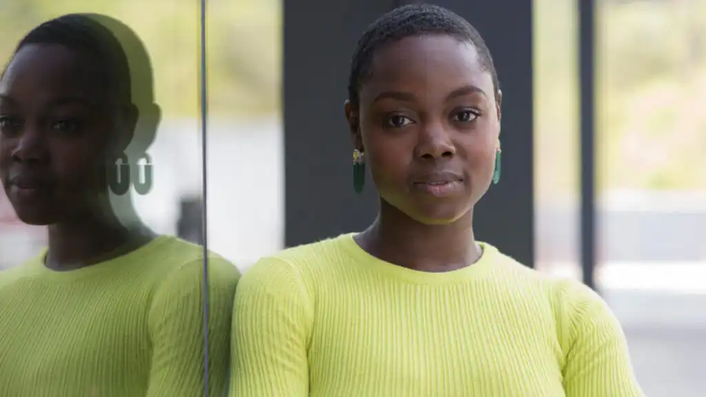 Stephanie Smith at Montague Plaza standing by glass window.