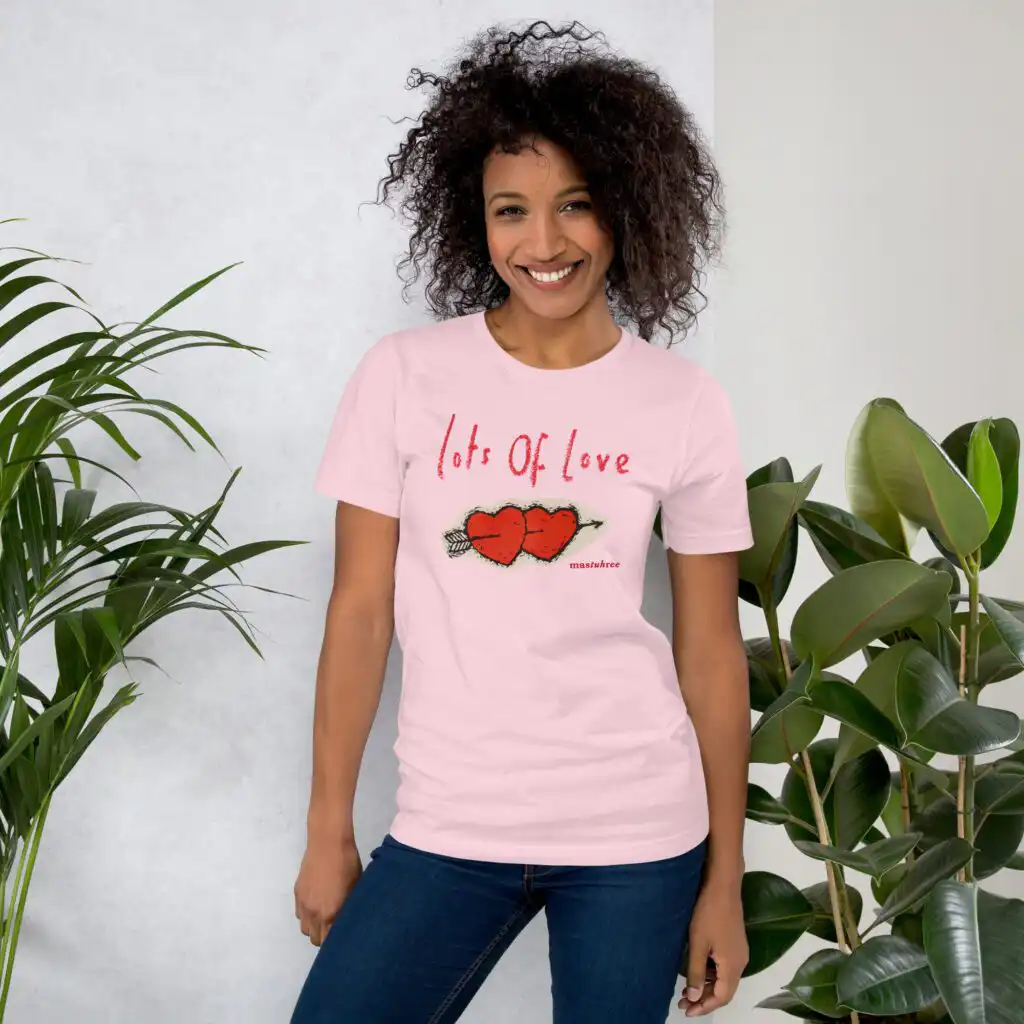 Pretty girl wearing a Love T-Shirt in a casual, stylish outfit. Lots of Love T-Shirt with heart graphic promoting kindness and positivity