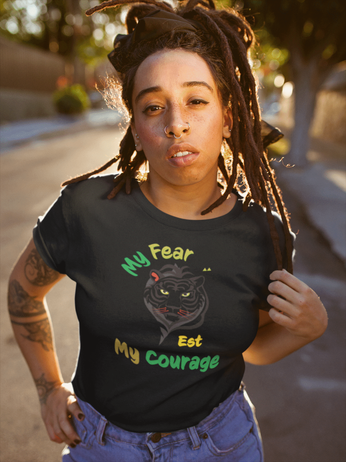 Person wearing “My Fear Est My Courage” t-shirt in minimalist black-and-white design, inspired by Bob Marley’s message of strength
