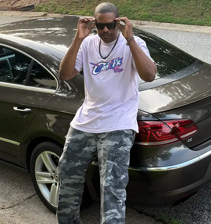 Young man wearing a Cancel Cancer T-shirt, spreading awareness for ovarian and all cancer symptoms and early detection.