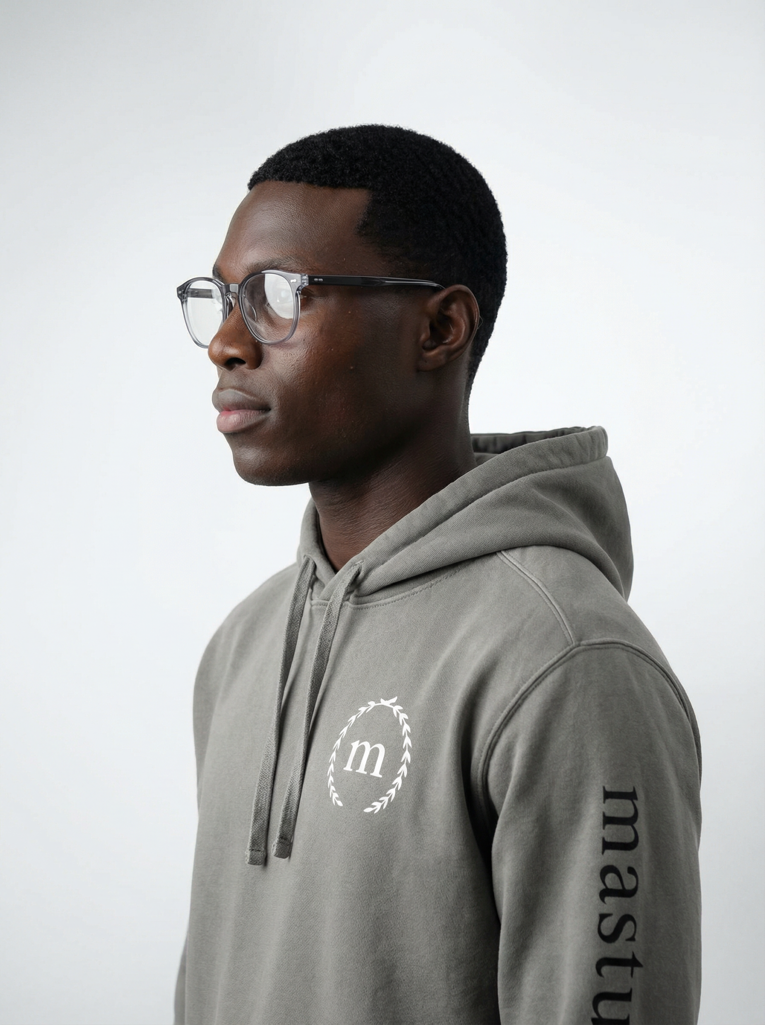 Close-up left-side view of a young man wearing the Grey University Hoodie by Mastuhree, showcasing premium fabric, relaxed fit, and elevated streetwear style
