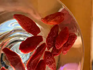 Goji berries in glass jar with warm light