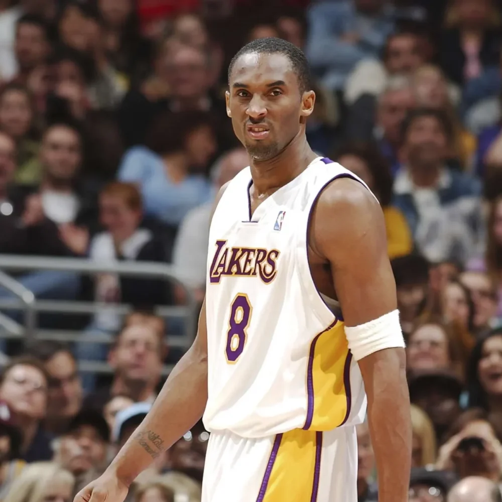 NBA guard wearing Los Angeles Lakers jersey during historic 81-point game, standing on court in white and purple Nike basketball sneakers. Photo#2