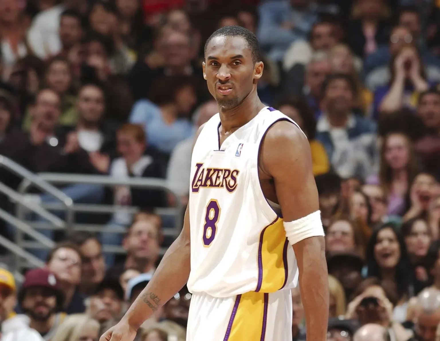 NBA guard wearing Los Angeles Lakers jersey during historic 81-point game, standing on court in white and purple Nike basketball sneakers. Photo#2